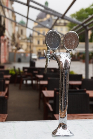 beer tap in the drops after rain in a street cafe Old Lvivの写真素材
