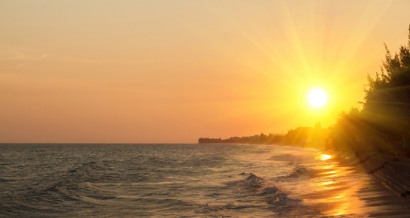 sunset over the sea and the beach with clear skiesの写真素材