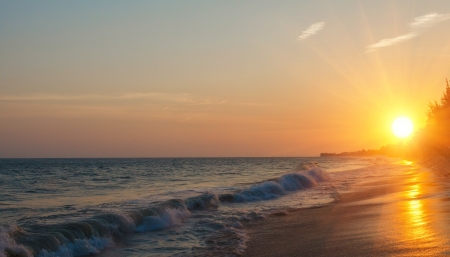 sunset over the sea and the beach with clear skiesの写真素材