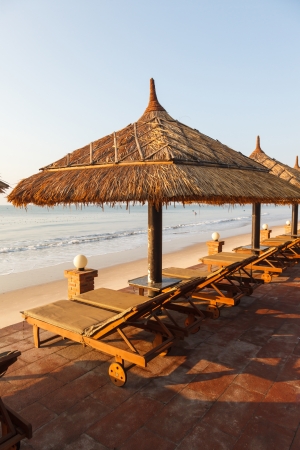 pool, sunbed, umbrellas on background of the sea and sky at dawnの写真素材