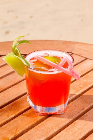 alcohol cocktail on the wooden table with crushed iceの写真素材