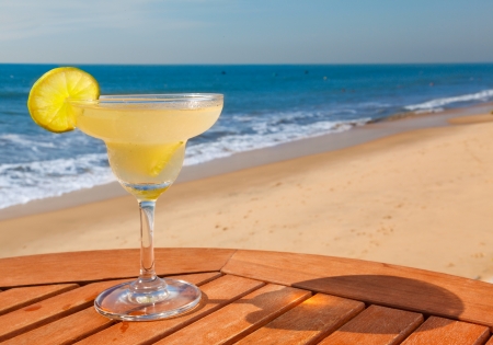 daiquiri cocktail with ice on the table against the background of sea and skyの写真素材