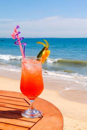 Tequila Sunrise cocktail on the wooden table with crushed iceの写真素材