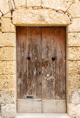 old wooden front door to the house in the Mediterraneanの写真素材