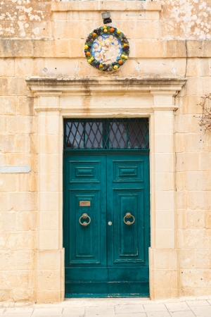old wooden front door to the house in the Mediterraneanの写真素材