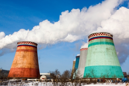 Smoking pipes of thermal power plant against blue skyの写真素材