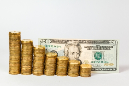 Dollar banknotes and coins on white backgroundの写真素材