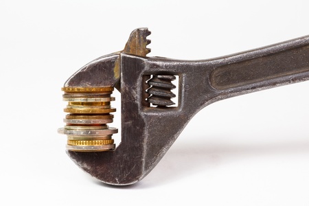 wrench and coins on white backgroundの写真素材