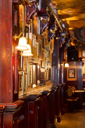 Inside view of pub, wooden interior of the bar, a wall with a lamp and beyondのeditorial素材