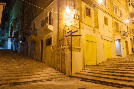 narrow old street and stairs in Valletta in a warm summer nightの写真素材