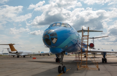 blue aircraft on the platform airport in the sun in summerの写真素材