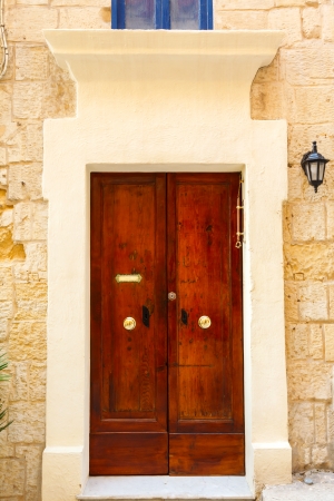 old wooden front door to the house in the Mediterraneanの写真素材