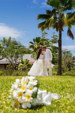 wedding bouquet of frangipani and newlywedsの写真素材