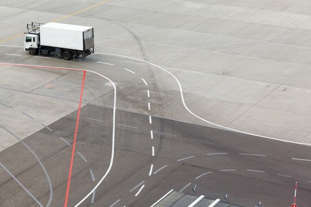 truck on airfield and markings on apronの写真素材