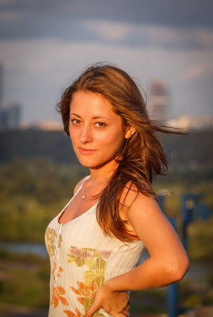 young girl on a background of blue sky and skyscrapers in Moscowの写真素材