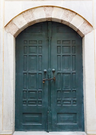 green old wooden door in a traditional Turkish house in Istanbulの写真素材