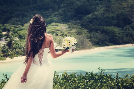 wedding bouquet of frangipani and groom on the background the bay Seychellesの写真素材