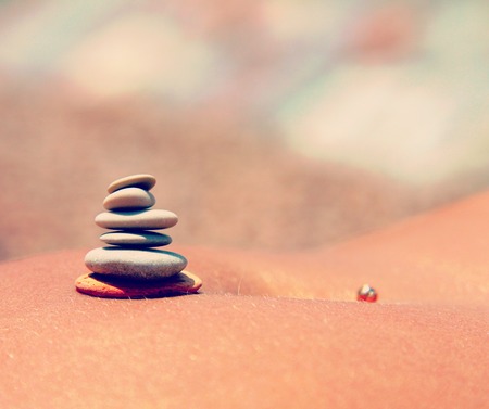 pyramid of small stones on the female abdomen closeupの写真素材