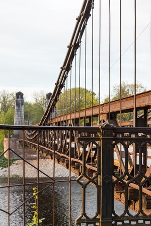 old rusty steel suspension bridge of forged elements. Ostrovok Russiaの写真素材