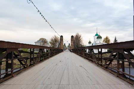 old rusty steel suspension bridge of forged elements. の写真素材