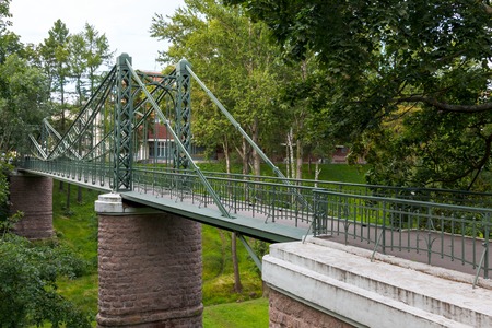 old rusty steel suspension bridge of forged elements. Russiaの写真素材