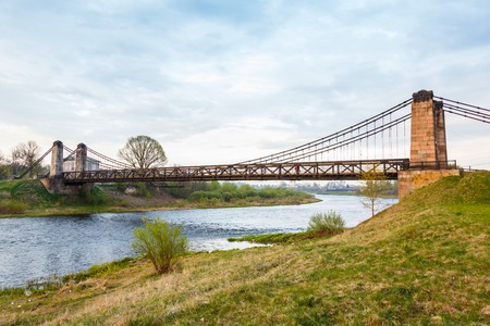 old rusty steel suspension bridge of forged elements. Ostrovok Russiaの写真素材