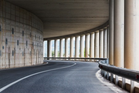 bend of the road in a tunnel with columns in the rock on the island of Sardinia, Italyの写真素材