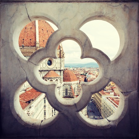 views of the Cathedral Santa Maria del Fiore through the fence ornament bell tower in Florence, Italyの写真素材