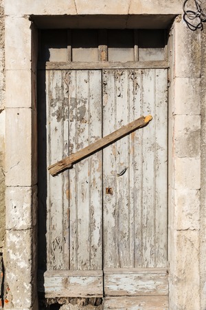 old vintage wooden door in a house on the island of Sardinia, Italyの写真素材