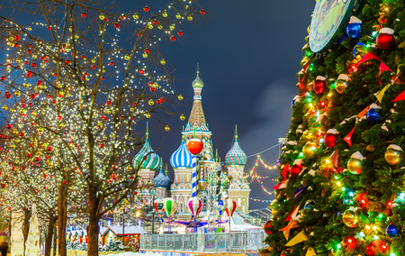 Decorations for New Year and holidays. Christmas balls on tree branches near to St. Basil's Cathedral on Red square in Moscowの写真素材