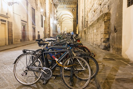Italian old bicycles leaning against a wall in the historic centre of Florenceの写真素材