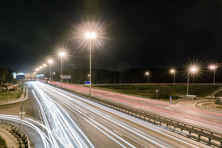 transport metropolis, traffic and blurry lights of cars on multi-lane highways and dense road...