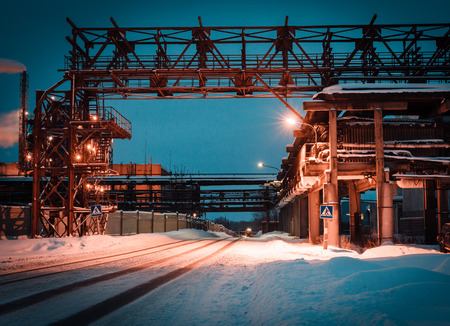 many pipes and smokestacks with industrial tower of metal on the chemical industry at nightの写真素材