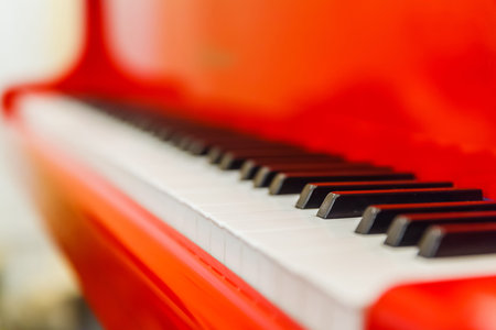 white and black keys of red piano closeupの写真素材