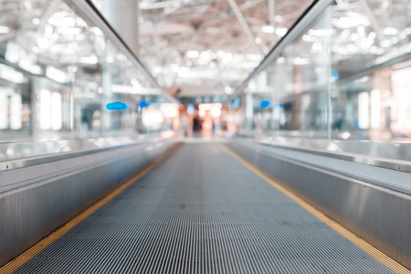 travelator at the airport and a metal roof and blurred lightsの写真素材