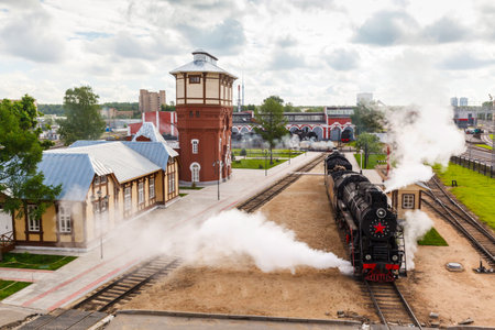 old black steam locomotive in Russia at the summer at the old railway station
