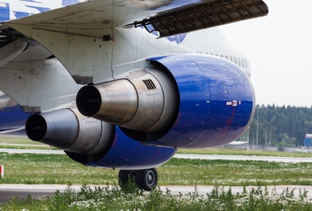 Wing and two jet engine jet airliner on the background of the runway