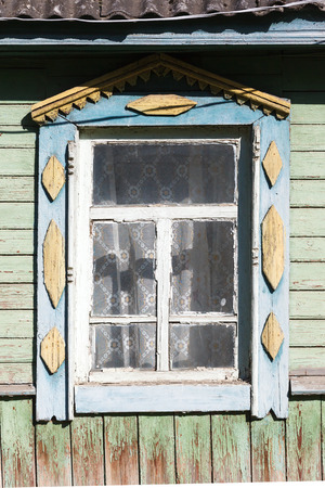 Carved window in old National russian wooden country houseの写真素材