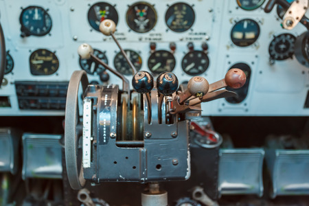 Engine Controls and other devices in the cockpit of an old airplaneの写真素材