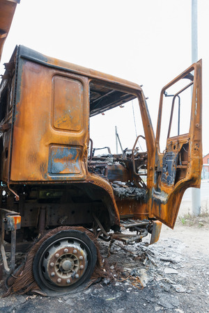 truck completely burned on the roadside, rusty cabin and car parts closeupの写真素材