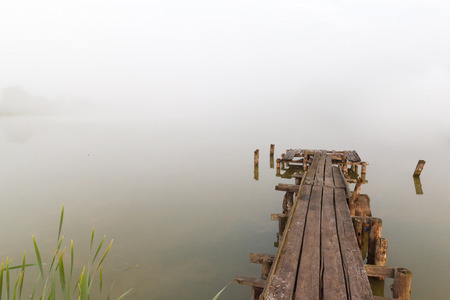 old wooden pier on a misty lakeの写真素材