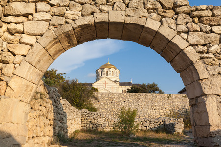 Hersonissos, stone arch and St. Vladimir's ancient Cathedral in Chersonese, Sevastopol, Crimea Russiaの写真素材