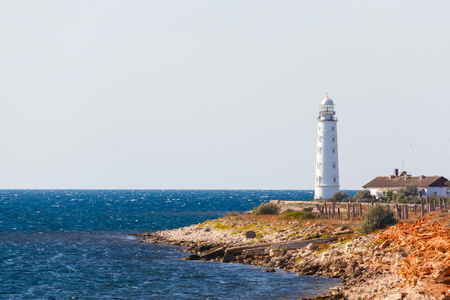 white lighthouse Hersones and road on the background of the sea in summerの写真素材