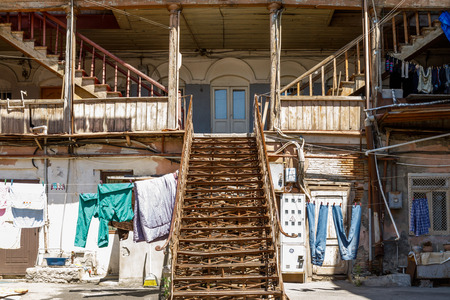 A typical georgian yard of an old traditional wooden house and clothes and linen drying on the ropes. Tbilisi Georgia, Caucasus mountains.の写真素材