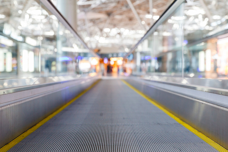 travelator at the airport and a metal roof and blurred lightsの写真素材