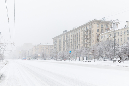 Heavy snowfall in Moscow. Snow-covered roads. Houses and streets during blizzard. Collapse of public services.の写真素材