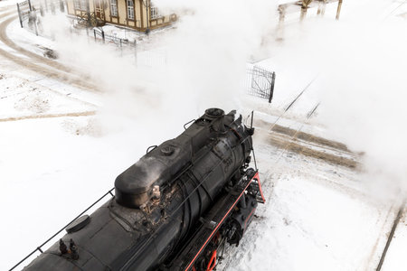 old black steam locomotive in Russia in the winter on a background of snow.