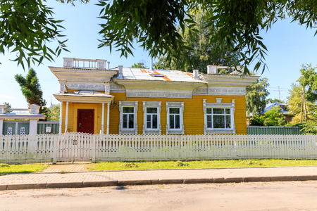 Wooden house with carved polisade in Vologda. Russian traditional architecture lies in wooden houses with manually carved decorations, often painted in white.の写真素材