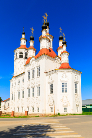 Russian white orthodox Temple of the Entry of the Lord into Jerusalem against the blue sky The Nativity Church, Totma, Russia. Architectural forms reminiscent of a ship.の写真素材
