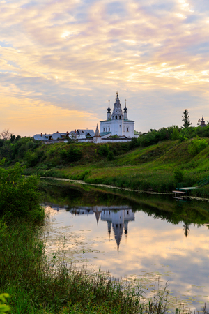 Beautiful panoramic view of Suzdal in summer at sunrise. the church and its reflection in the river in Suzdal. Suzdal is a famous tourist attraction and part of the Golden Ring of Russia.の写真素材
